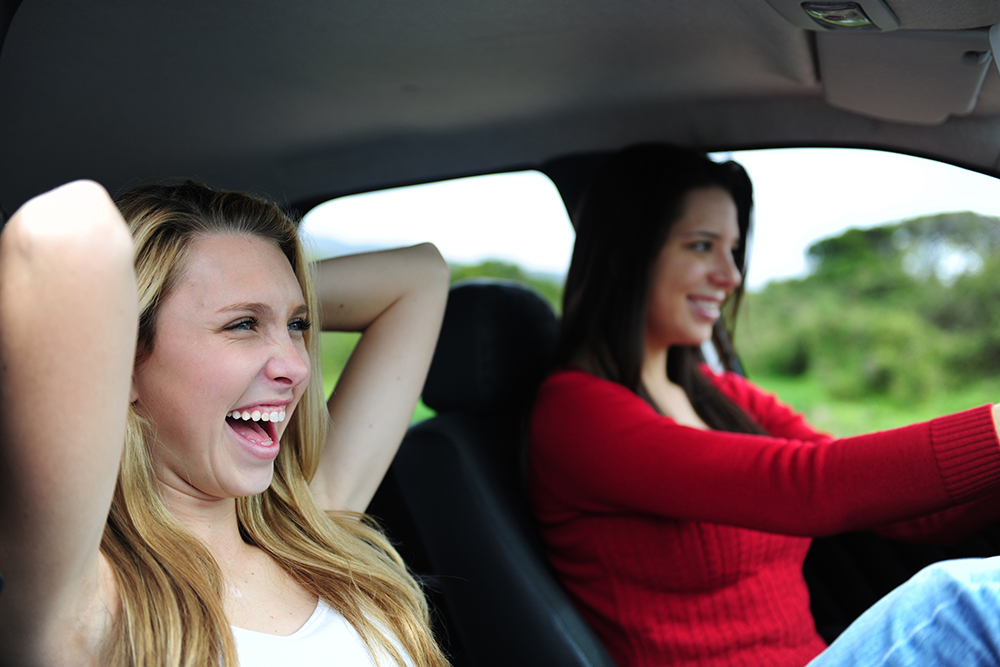 two happy women in a car