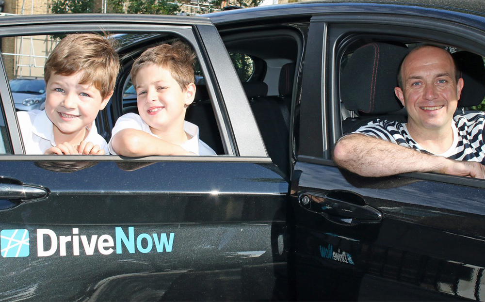 Guy Brandon and sons with a DriveNow BMW in London