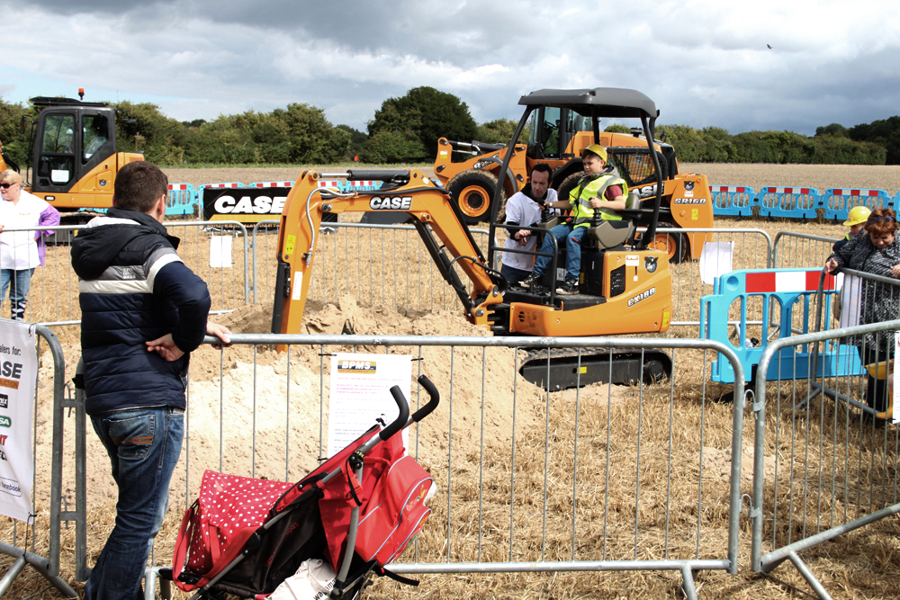 A child drives a digger at CarFest