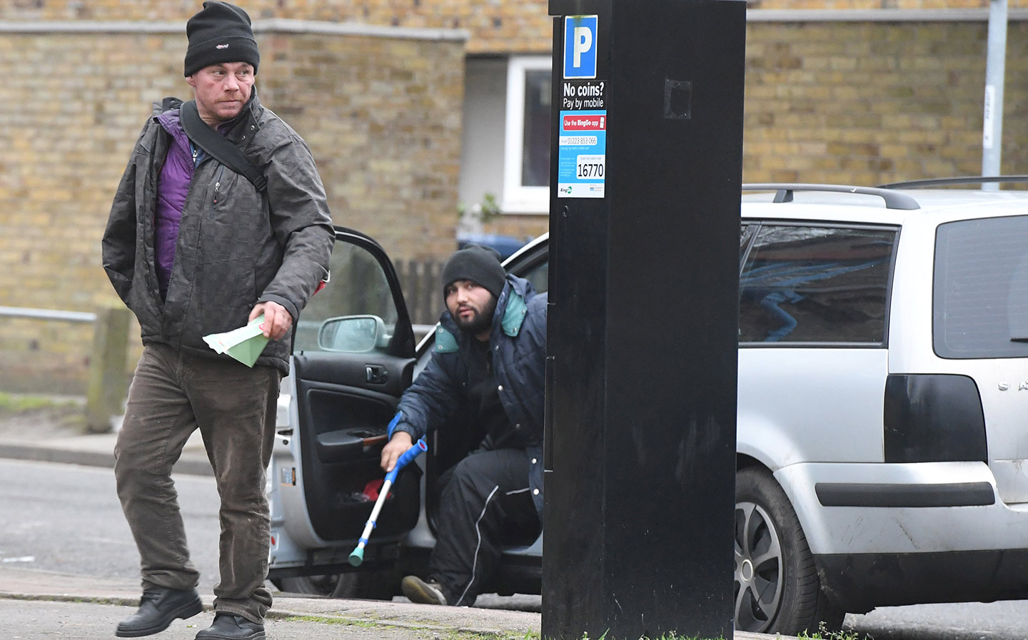 Beggars park and feed the meter before a day on the streets