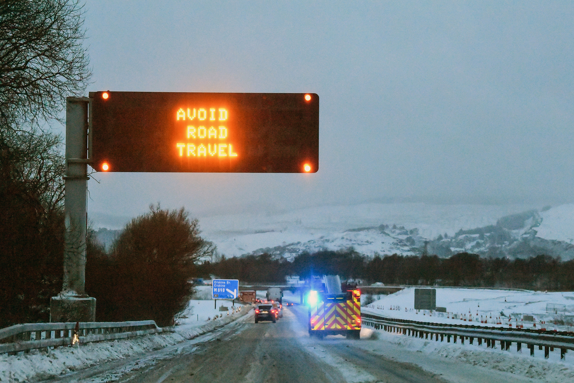 GLASGOW, UNITED KINGDOM - FEBRUARY 28: A road warning sign advising not to travel on the M8 on February 28, in Glasgow, Scotland. Freezing weather conditions dubbed the 'Beast from the East' bring snow and sub-zero temperatures to the UK. Amber warnings are in place in northern England, the East Midlands, London, the east and south-east of England. Scotland's weather warning has been upgraded to red, which means risk to life, widespread damage, travel and power disruption are likely. (Photo by Jeff J Mitchell/Getty Images)
