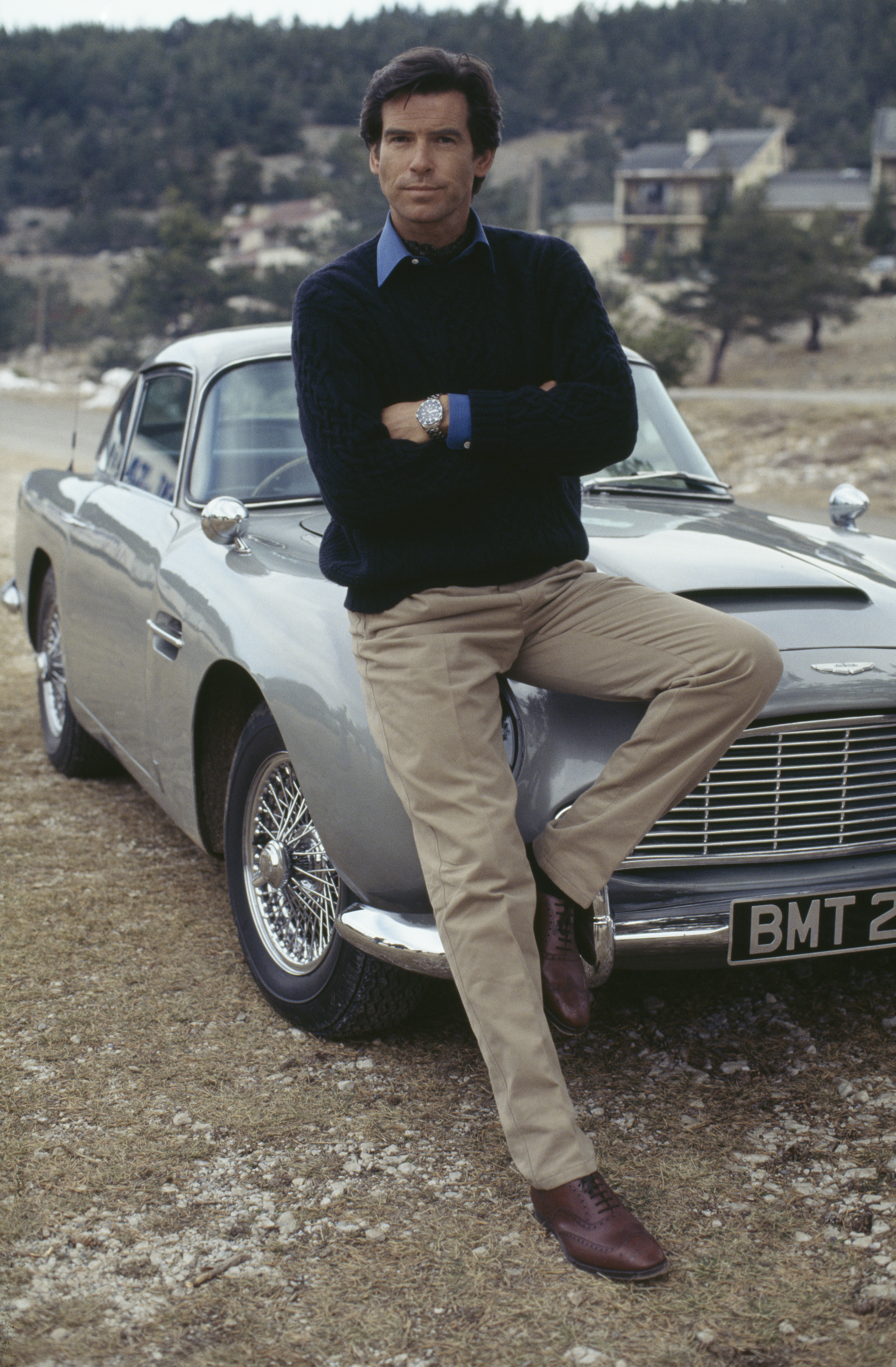 Pierce Brosnan poses with an Aston Martin DB5 in a publicity still for GoldenEye, 1995. (Photo by Keith Hamshere/Getty Images)
