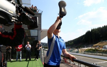 Billy Monger celebrates Spa podium with "leggy" champagne swig