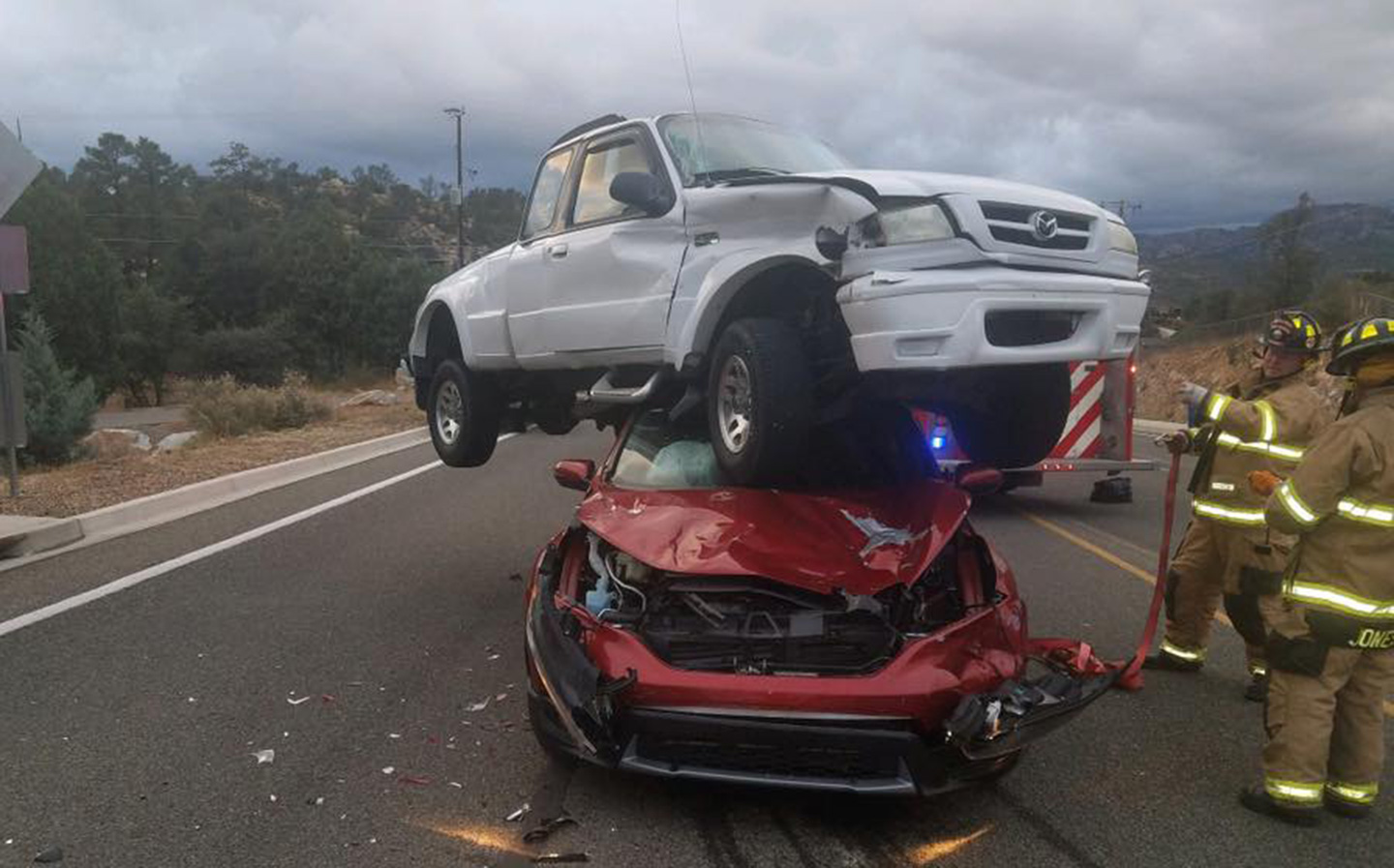 Pick-up truck lands on top of car in horrific car crash