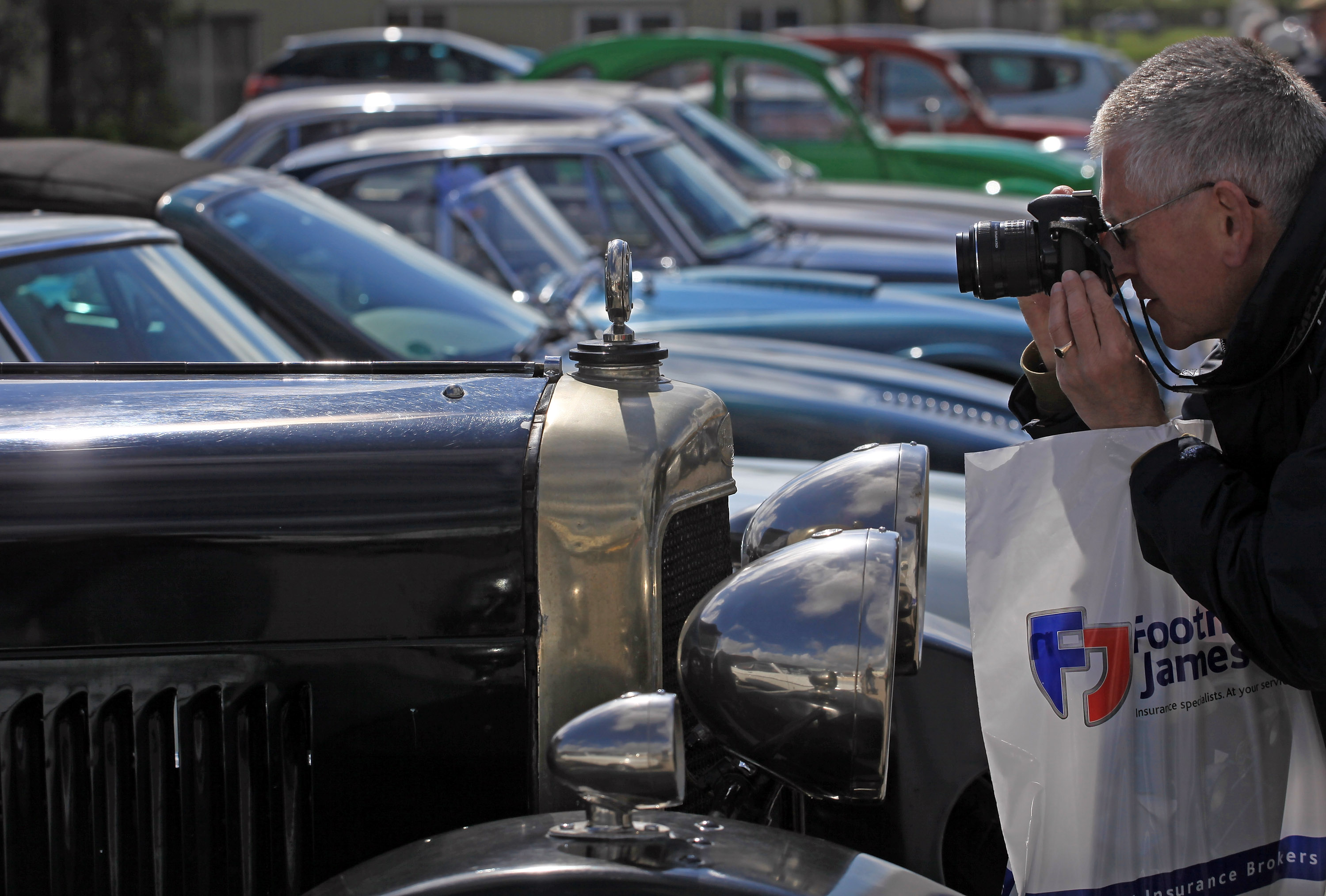 A visitor to the Footman James Bristol Classic Car Show stops to take a photograph. (Photo by Matt Cardy/Getty Images)