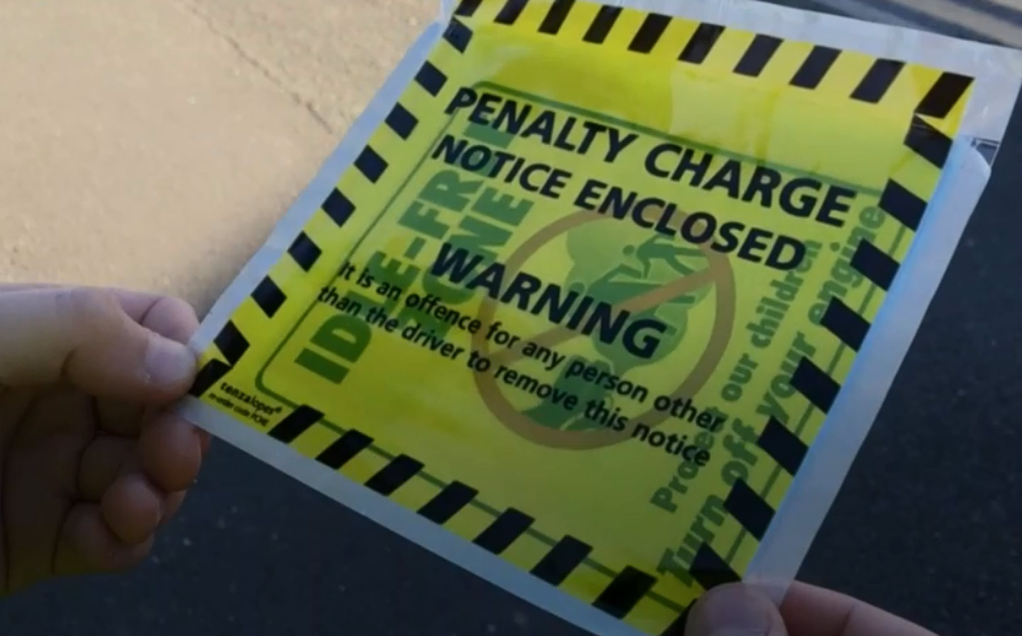 Primary school pupils handing parking tickets to polluting parents