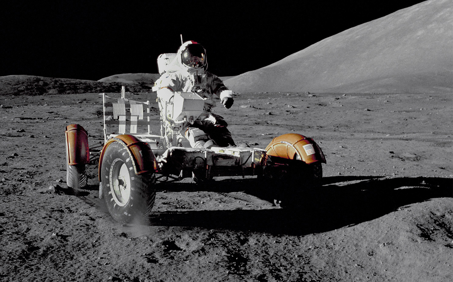 Apollo 17 commander Eugene A. Cernan rides the Lunar Roving Vehicle (LVR) during his first space walk at the Taurus-Littrow landing site becoming the last man to walk on the Moon on December 12, 1972