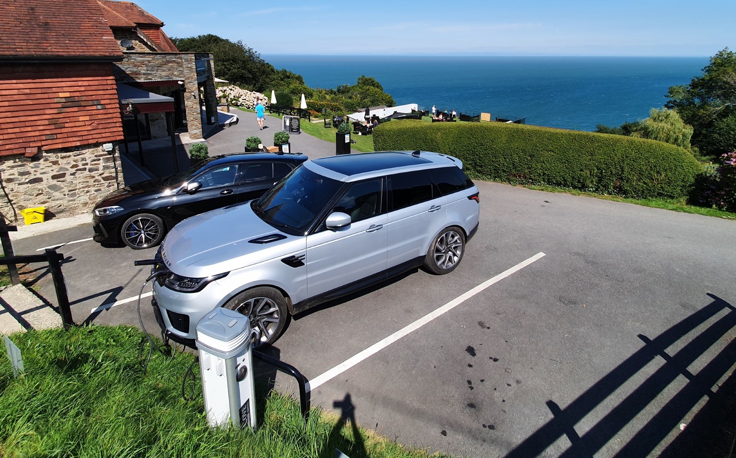 Charging a plug-in hybrid car at Sandy Cove hotel - Range Rover Sport P400e plug-in hybrid 2020 beach sunset scene - long-term test review by Will Dron