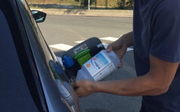 Pouring AdBlue into a car