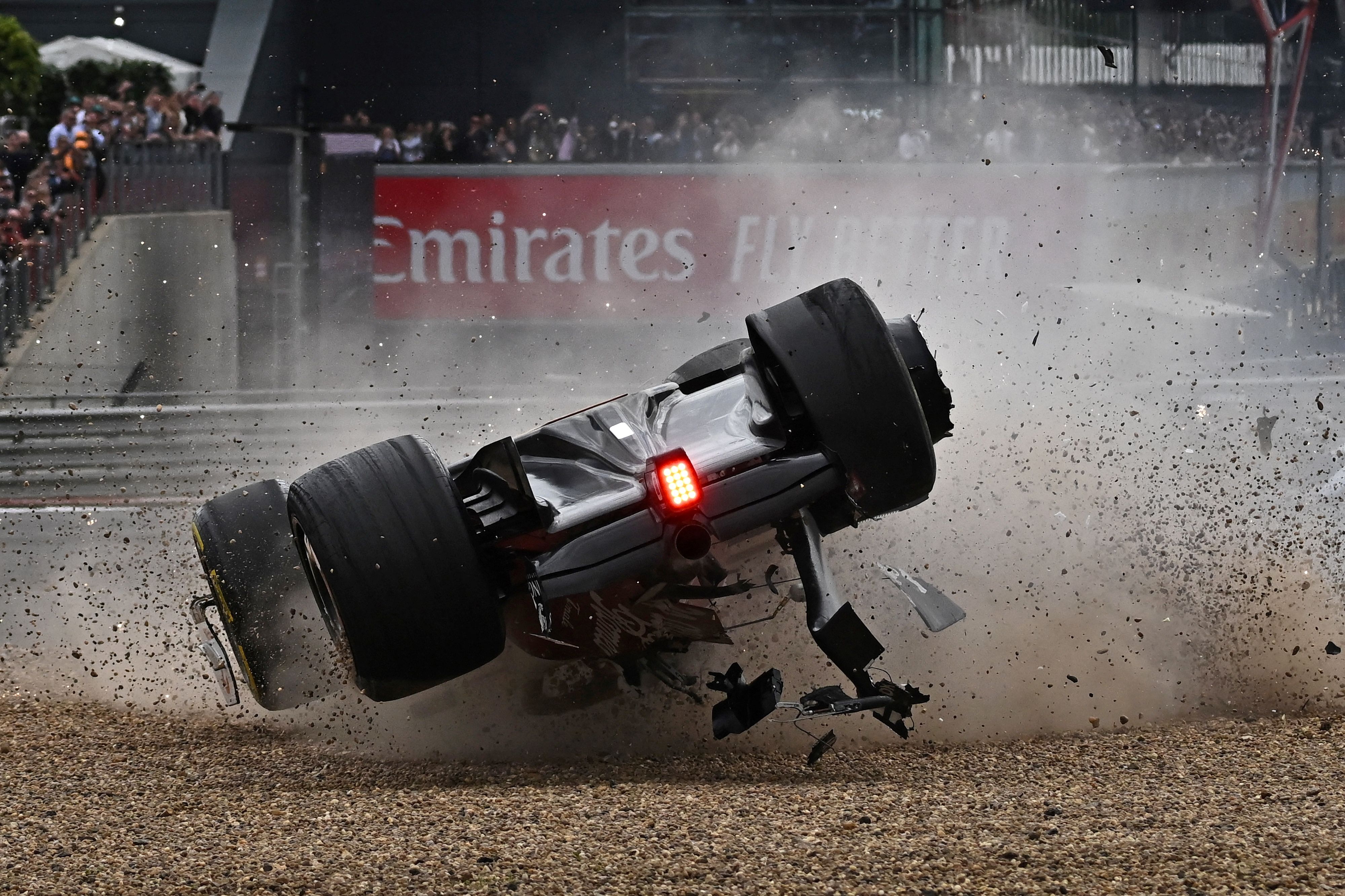 Chinese driver Zhou Guanyu is flipping upside-down in his Alfa Romeo F1 car during his crash at the 2022 British GP