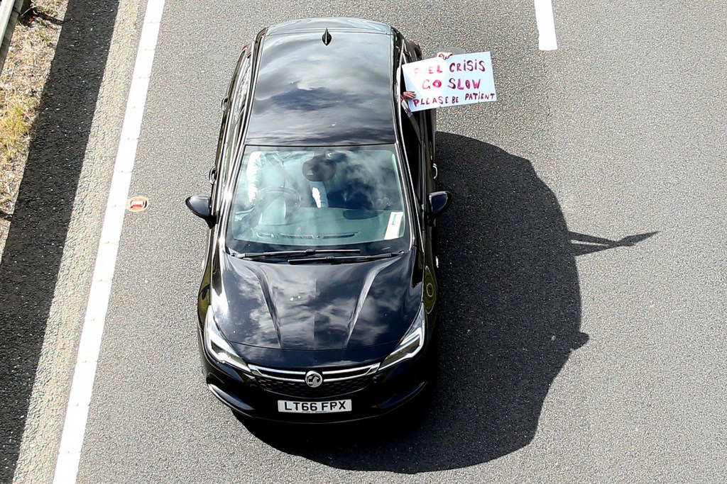 Protesters hold up signs as they slow the traffic down on the A64 on July 04, 2022 in York, England (Photo by Cameron Smith/Getty Images)