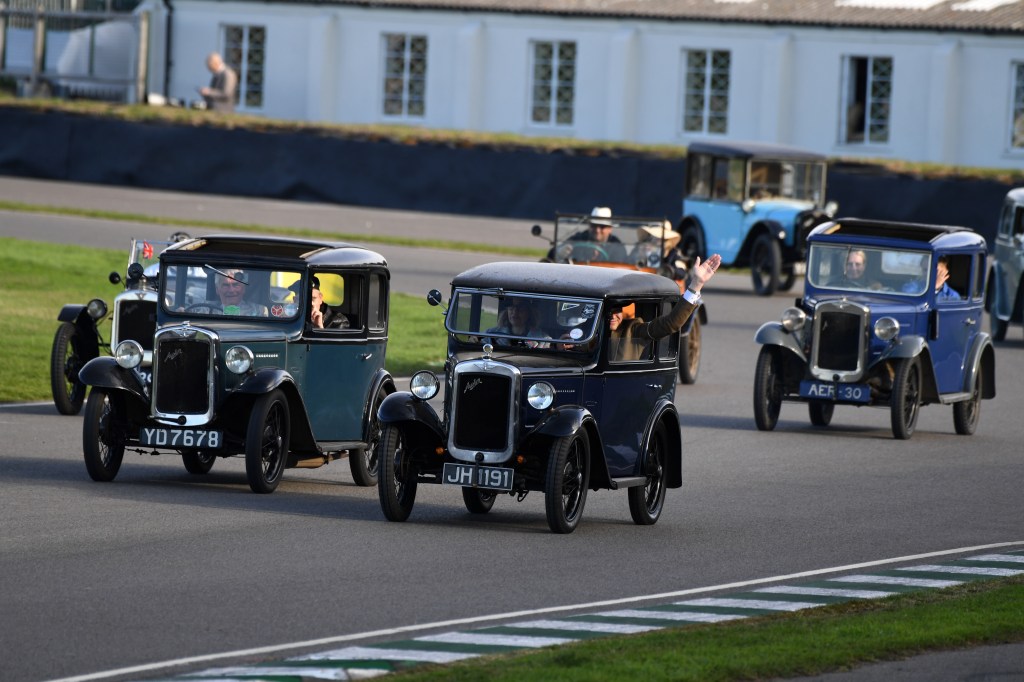 Will Dron waves from the passenger seat of his late father's Austin Seven, driven by stepmum Charis. Photo: Jeff Bloxham