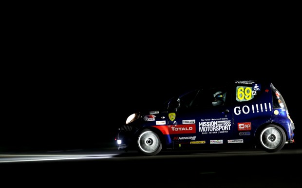 Nik Berg driving at night in a Citroen C1 at the Mission Motorsport Race of Remembrance 2022