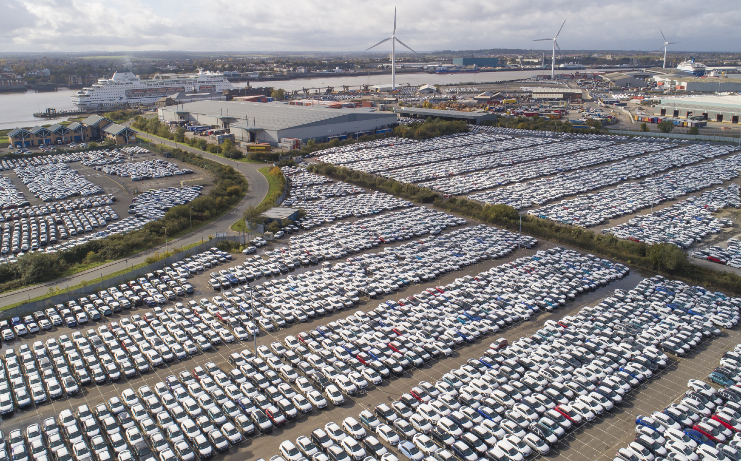 New automobiles in a car park at the Port of Tilbury