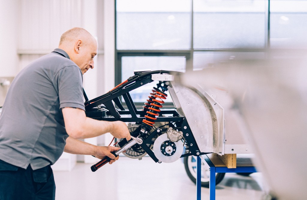 An engineer at The Little Car Company works on building a new Aston Martin DB5 Junior.