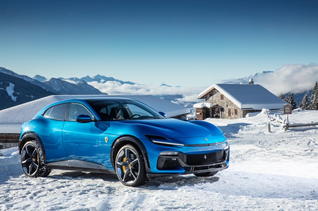 Ferrari Purosangue in blue corsa colour static shot in Dolomite mountains