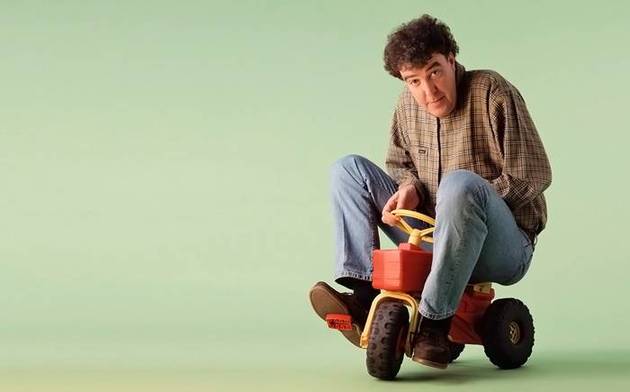 Jeremy Clarkson riding a toy tractor