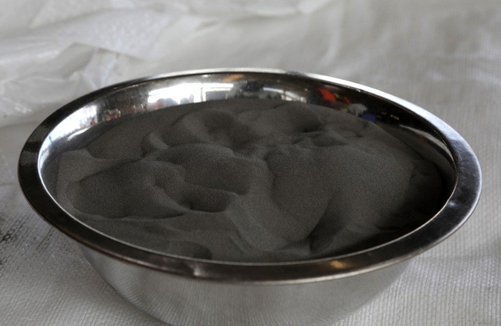 Nickel powder sits in a bowl for a photograph at the BHP Group Ltd. Kwinana Nickel Refinery in Kwinana, Western Australia, Australia, on Friday, Aug. 2, 2019. The world's biggest miners, including BHP Group and Glencore Plc, are finally firm believers in the electric vehicle battery revolution -- what they don't agree on is which metals will deliver the best long-term exposure to the developing global market. Photographer: Philip Gostelow/Bloomberg via Getty Images