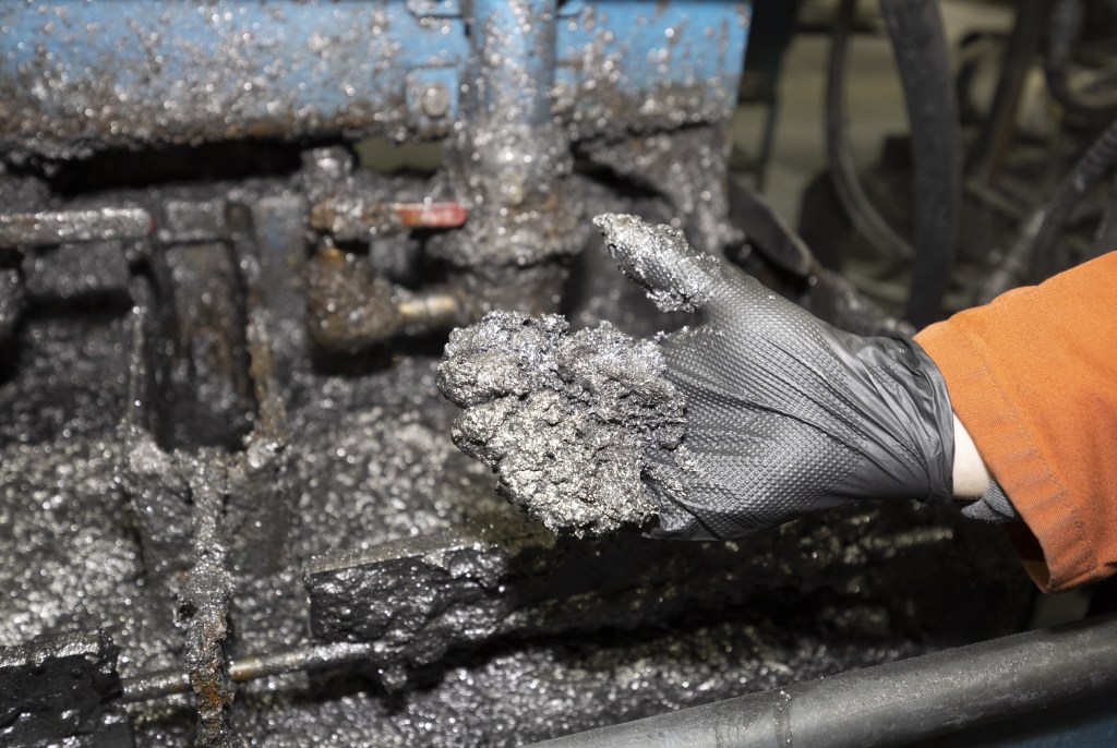 A worker holds graphite flakes at the Nouveau Monde Graphite facility in Saint-Michel-des-Saints, Quebec, Canada, on Thursday, Oct. 6, 2022. Nouveau Monde Graphite Inc. bought a site in Becancour for a C$923 million plant that could start producing battery materials in three years -- providing it can raise enough money to build facilities. Photographer: Christinne Muschi/Bloomberg via Getty Images