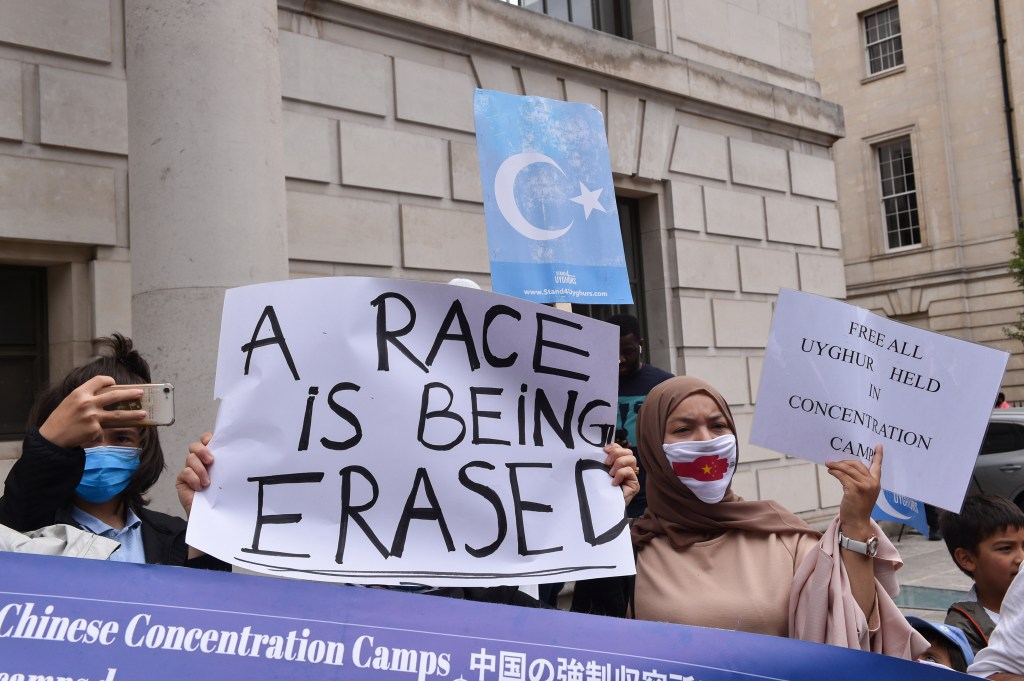 LONDON, UNITED KINGDOM - 2022/07/31: Protesters hold a banner and placards expressing their opinion during the demonstration. Uyghurs and UK Muslim organizations gathered opposite the Chinese embassy in London to protest against the Chinese government's involvement in ongoing human rights abuses against Uyghurs and other ethnic minorities. (Photo by Thomas Krych/SOPA Images/LightRocket via Getty Images)