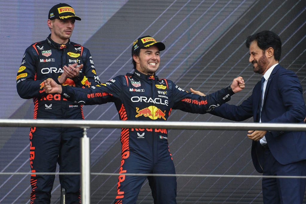 BAKU, AZERBAIJAN - APRIL 30: Sergio Perez of Mexico and Oracle Red Bull Racing (C) celebrates his win on the podium as Max Verstappen of the Netherlands and Oracle Red Bull Racing (L) and Mohammed Ben Sulayem (R) look on during the F1 Grand Prix of Azerbaijan at Baku City Circuit on April 30, 2023 in Baku, Azerbaijan. (Photo by Vince Mignott/MB Media/Getty Images)