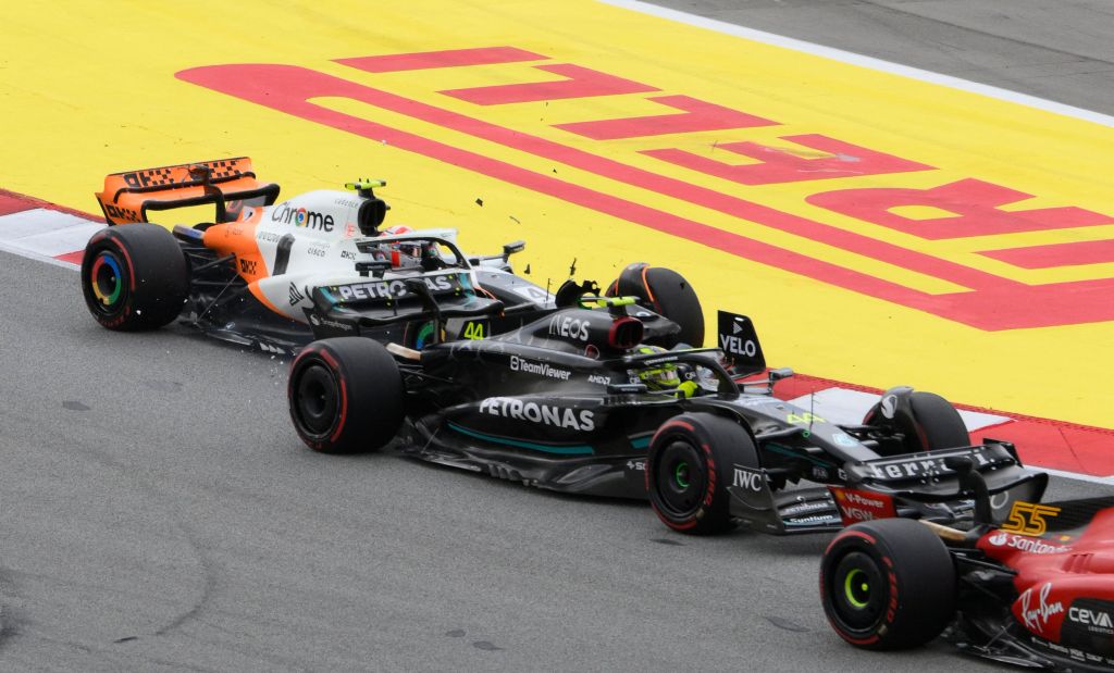 TOPSHOT - Mercedes' British driver Lewis Hamilton (C) and McLaren's British driver Lando Norris (L) collude during the Spanish Formula One Grand Prix race at the Circuit de Catalunya on June 4, 2023 in Montmelo, on the outskirts of Barcelona. (Photo by Josep LAGO / AFP) (Photo by JOSEP LAGO/AFP via Getty Images)
