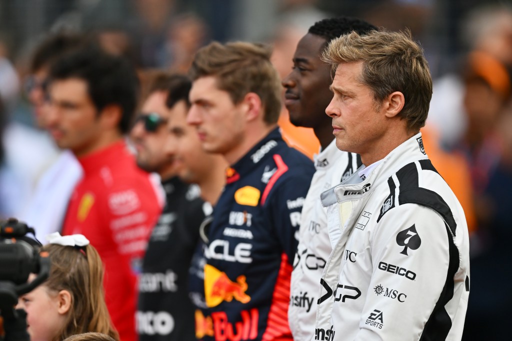 NORTHAMPTON, ENGLAND - JULY 09: Brad Pitt, star of the upcoming Formula One based movie, Apex, and Damson Idris, co-star of the upcoming Formula One based movie, Apex, stand for thr national anthem on the grid during the F1 Grand Prix of Great Britain at Silverstone Circuit on July 09, 2023 in Northampton, England. (Photo by Dan Mullan/Getty Images)