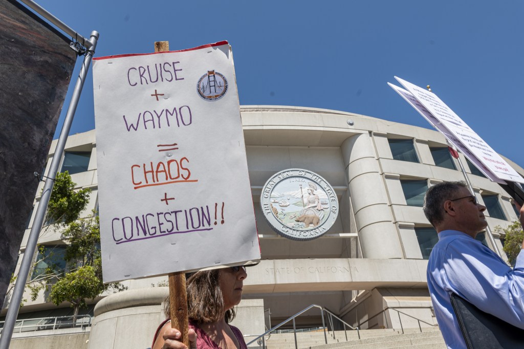 Members of the San Francisco Taxi Workers Alliance and supporters during a rally outside the California Public Utilities Commission headquarters in San Francisco, California, US, on Monday, Aug. 7, 2023. Taxi drivers and their supporters hope to stop the commission from lifting current restrictions and allowing Waymo and Cruise to offer driverless commercial passenger service 24/7 anywhere in the city, reported KALW. Photographer: David Paul Morris/Bloomberg via Getty Images