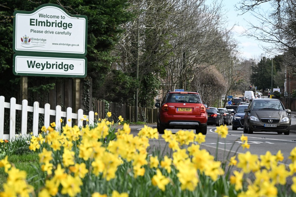 Vehicles queue along the street going into Weybridge south-west of London on March 16, 2024, as the London orbital motorway M25 sees it's first total closure over a weekend since it's opening in 1986. The M25 will be closed between junctions 10 and 11 from Friday 15 March 2024 evening until Monday 18 March 2024 morning to demolish the Clearmount bridleway bridge and install a very large gantry. (Photo by JUSTIN TALLIS / AFP) (Photo by JUSTIN TALLIS/AFP via Getty Images)