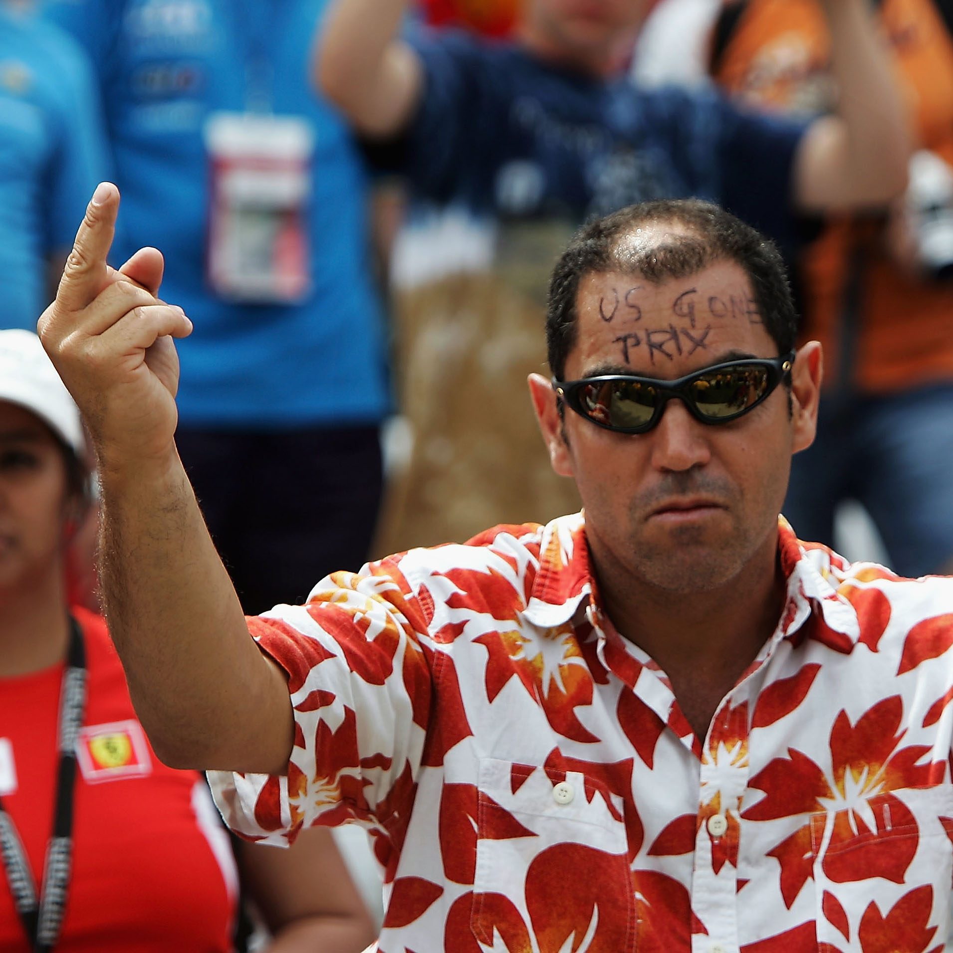 INDIANAPOLIS, IN - JUNE 19:  American Formula One fan puts his middle fingers up and writes " US Gone Prix " on his head after all the teams with Michelin tyres retired after the warm up lap during the United States F1 Grand Prix at the Indianapolis Motor Speedway on June 19, 2005 in Indianapolis, Indiana.  (Photo by Christopher Lee/Getty Images)