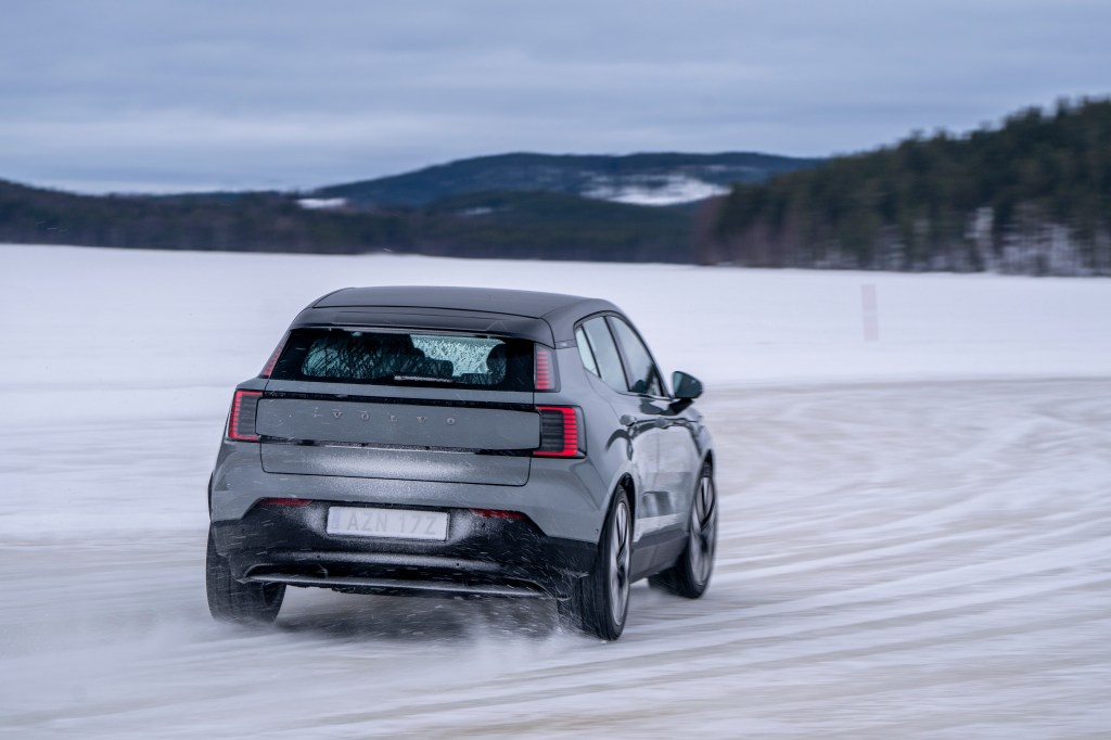 Will Dron sliding a grey Volvo EX30 on a frozen lake in Sweden.