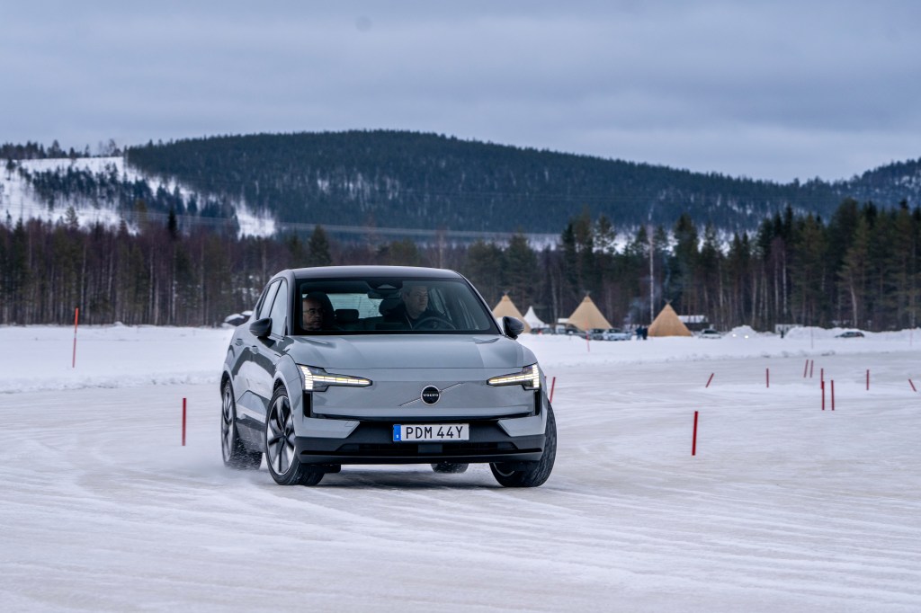 Will Dron driving a grey Volvo EX30 on a frozen lake in Sweden.