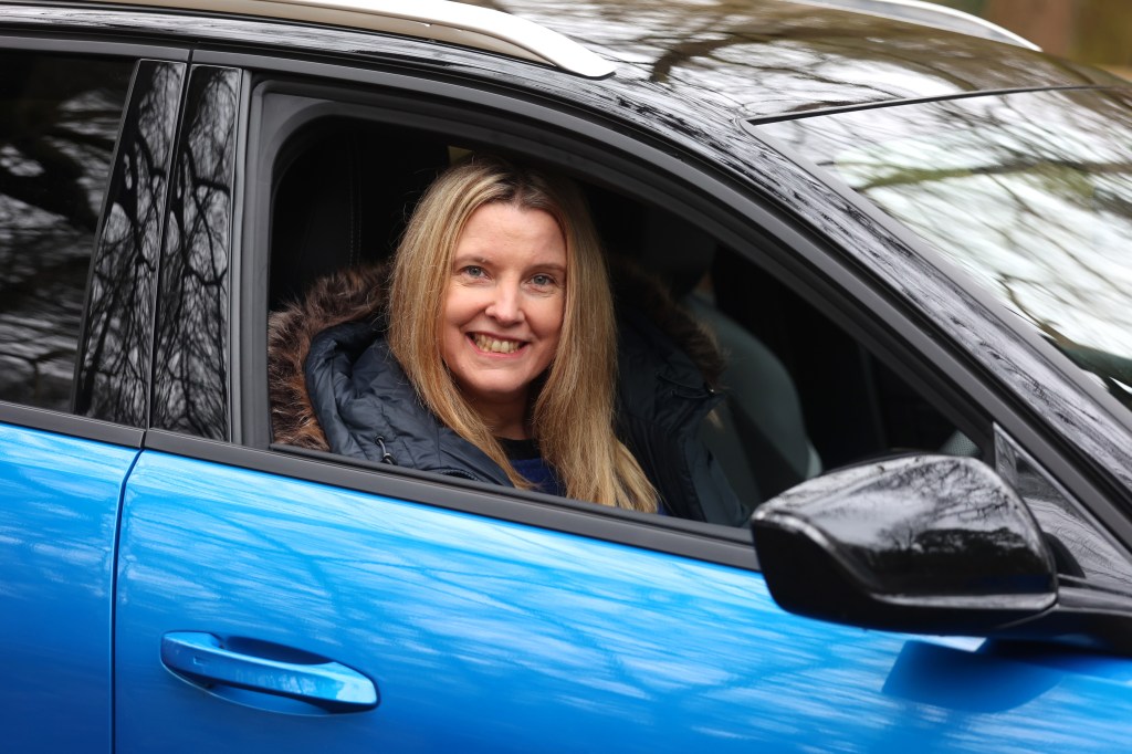Tina Milton smiles from the driving seat of the Vauxhall Astra Sports Tourer PHEV.