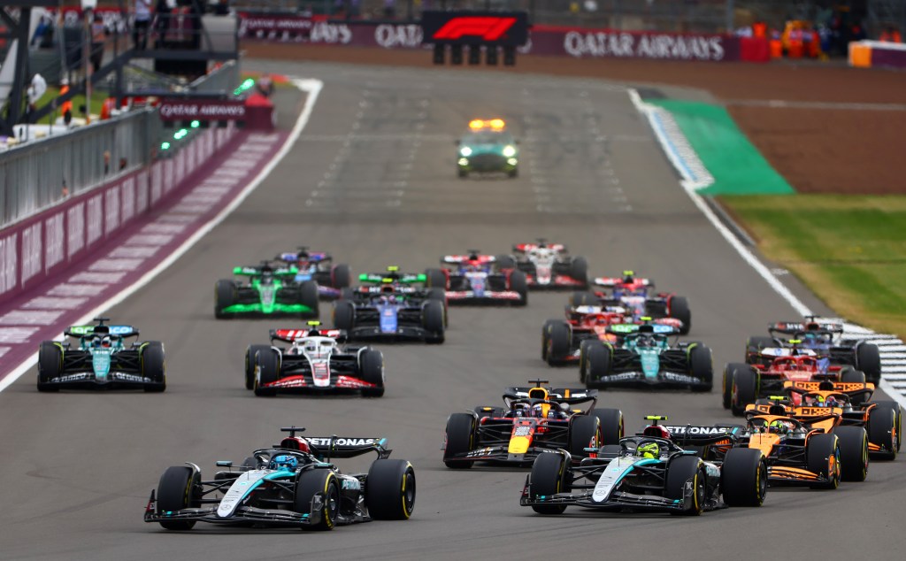 NORTHAMPTON, ENGLAND - JULY 07: George Russell of Great Britain driving the (63) Mercedes AMG Petronas F1 Team W15 leads Lewis Hamilton of Great Britain driving the (44) Mercedes AMG Petronas F1 Team W15 and the rest of the field into turn one at the start during the F1 Grand Prix of Great Britain at Silverstone Circuit on July 07, 2024 in Northampton, England. (Photo by Bryn Lennon - Formula 1/Formula 1 via Getty Images)