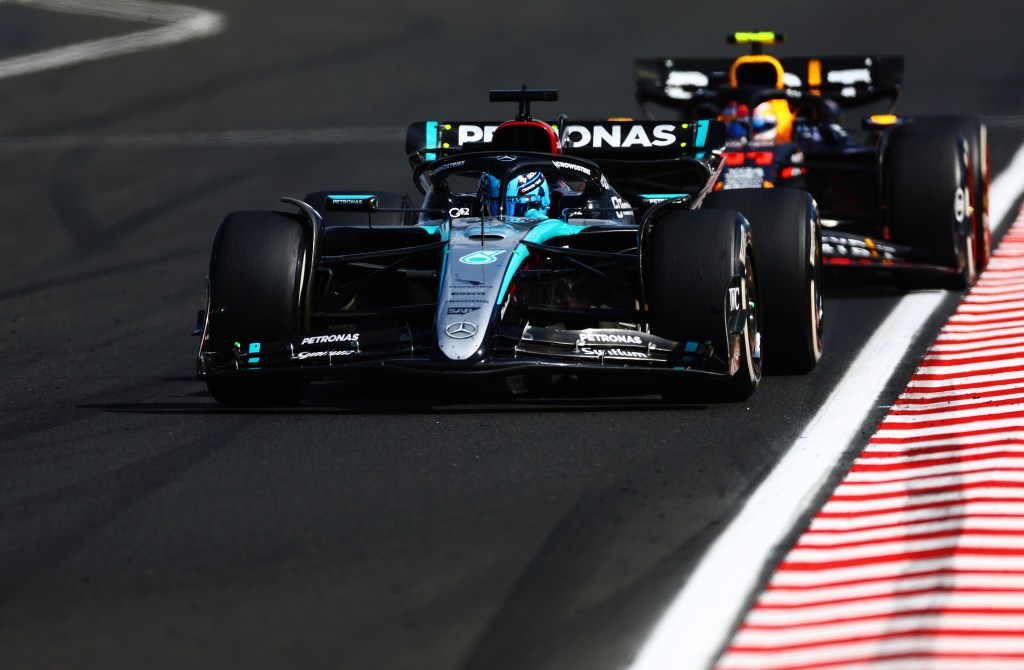 BUDAPEST, HUNGARY - JULY 21: George Russell of Great Britain driving the (63) Mercedes AMG Petronas F1 Team W15 leads Sergio Perez of Mexico driving the (11) Oracle Red Bull Racing RB20 during the F1 Grand Prix of Hungary at Hungaroring on July 21, 2024 in Budapest, Hungary. (Photo by Mark Thompson/Getty Images)