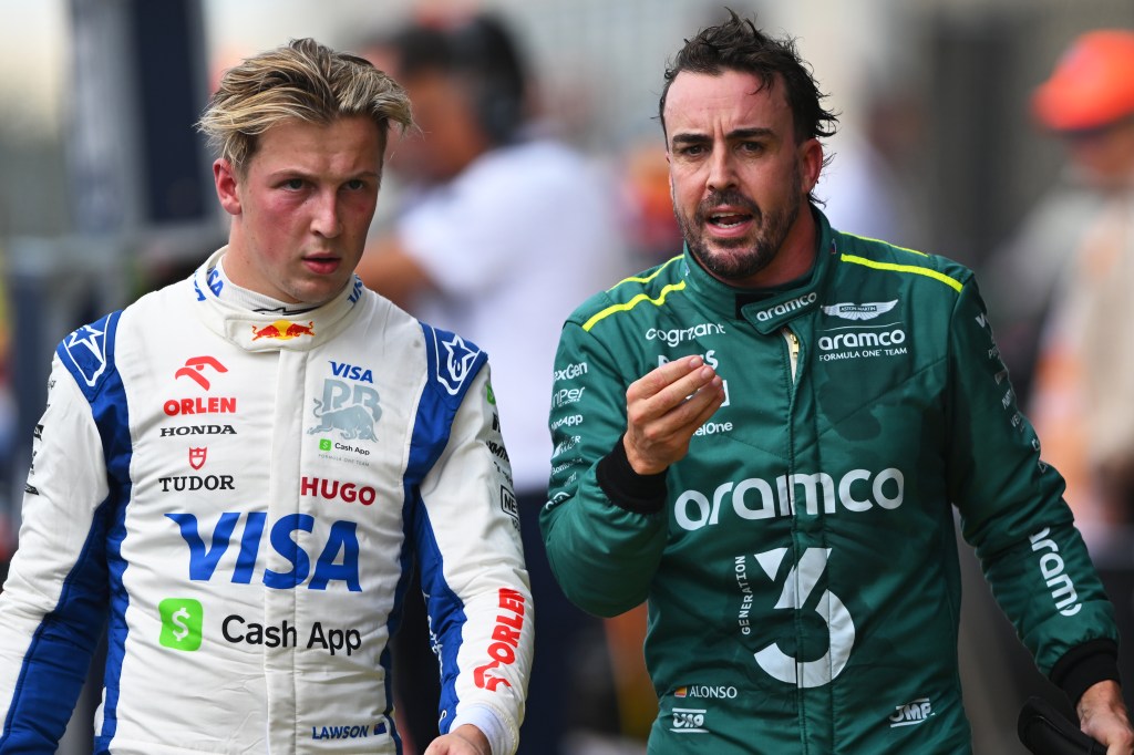 AUSTIN, TEXAS - OCTOBER 19: 16th placed Liam Lawson of New Zealand and Visa Cash App RB and 18th placed Fernando Alonso of Spain and Aston Martin F1 Team talk in parc ferme during the Sprint ahead of the F1 Grand Prix of United States at Circuit of The Americas on October 19, 2024 in Austin, Texas. (Photo by Rudy Carezzevoli/Getty Images)