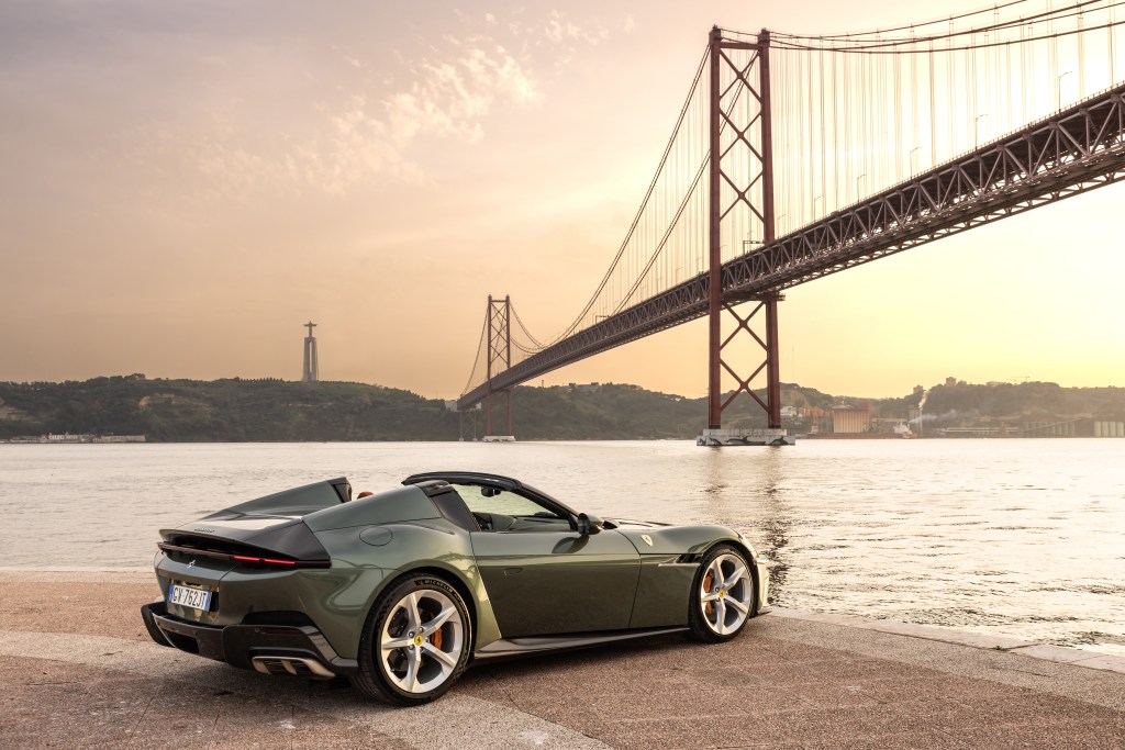 Ferrari 12Cilindri Spider static rear 3/4 image with Lisbon bridge background at sunset